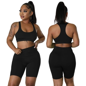 Macro detail of black two-piece sports set featuring racerback top and cycling shorts