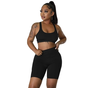 Front view of black high-waisted cycling shorts and ribbed sports bra set for fitness
