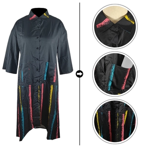Detail view of a black shirt dress featuring colorful stripe print and large utility pockets