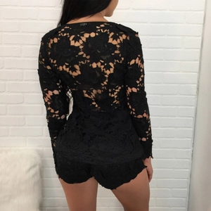 Detail of black floral lace fabric on the back of long-sleeved top and matching shorts set