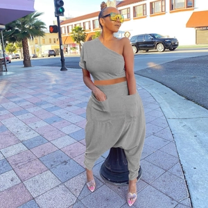 Detail showing the large cargo pocket on the grey cotton blend harem pants