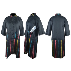 Detail view of the side pocket on a black shirt dress with colorful vertical paint stripes
