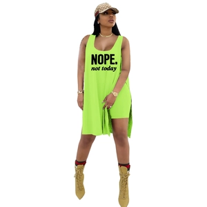 Detail of neon green two-piece set featuring NOPE. not today print and side slit long vest