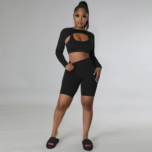 Three-piece black athletic set featuring halter vest, long sleeve shrug, and shorts