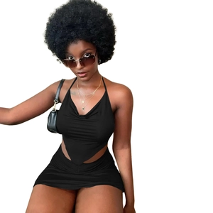 Close-up of black two-piece set featuring halter crop top and ruched mini skirt