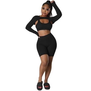 Three-piece black sports set featuring a shrug, U-neck tank top and high waist shorts