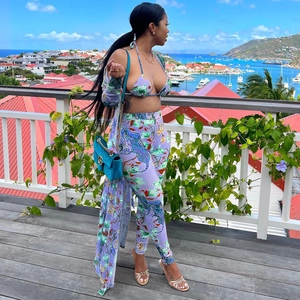 Detailed view of women's tiger print resort set with bikini, trousers, and cover-up