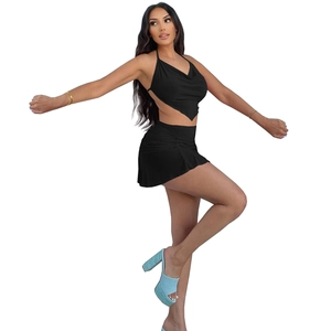 Macro detail of black halter neck top and ruched mini skirt set with stretch fabric texture