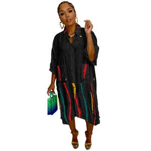 Detail of shirt dress featuring colorful paint brush stripes and large functional pockets