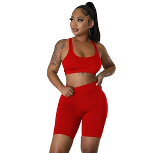 Close-up of red high-elasticity sports set with sports bra and high-waisted biker shorts