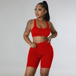 Three-piece red sports set with racerback bra and high-waist shorts on female model