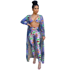 Three-piece purple bohemian set with floral prints, including top, pants, and long cardigan