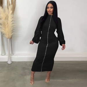Detail of a sleek black dress featuring a full-length silver zipper and ruched puffed sleeves