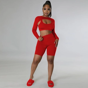 Detailed view of women's red 3-piece sportswear set with long sleeve shrug and shorts