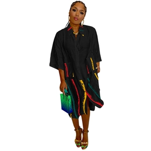Detail of plus size black shirt dress featuring colorful striped print and large pockets