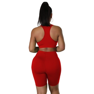 Rear view of red racerback sports top and high-waist biker shorts set for women