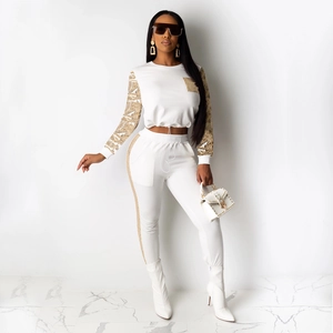 Women's white two-piece tracksuit with gold sequin sleeves and high-waist pants