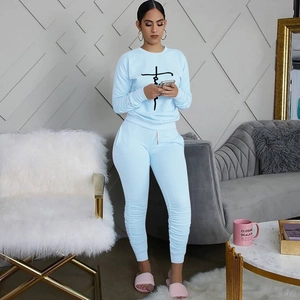 Detail of light blue tracksuit with Faith cross print and adjustable drawstring waist