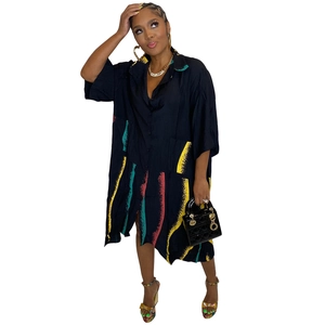 Detail of artistic abstract print on a loose black shirt dress with functional pockets