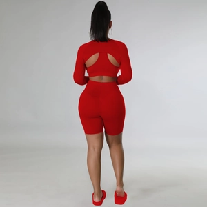 Close-up of red seamless high-stretch knitted gym set with backless long sleeve top