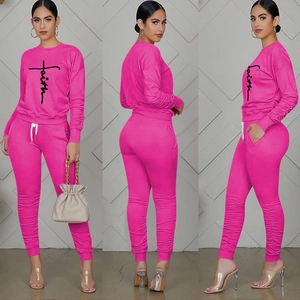 Detailed close-up showing the elastic cuffs and vibrant rose pink fabric of the tracksuit set