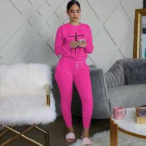 Close-up of rose red women's lounge set featuring black line art print on sweatshirt