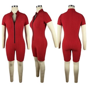 Three-way view of a red honeycomb textured athletic jumpsuit with black front zipper