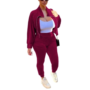 Close-up of burgundy tracksuit set featuring a zippered collar jacket and slim joggers