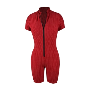Macro detail of red textured honeycomb fabric on short sleeve one-piece romper
