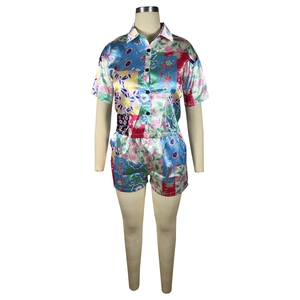 Detail of floral print satin two-piece set featuring short sleeve button shirt and shorts