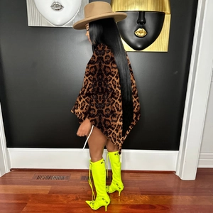 Detail of velvet leopard print shawl top paired with yellow thigh-high boots and a fedora