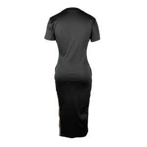 Détail du dos d'une robe moulante noire avec des bandes pailletées dorées sur le côté
