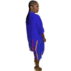 Detail of royal blue midi shirt dress with colorful wavy stripes and large side pockets