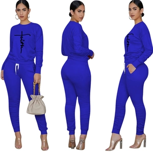 Detail of royal blue two-piece lounge set featuring Faith cross print and drawstring