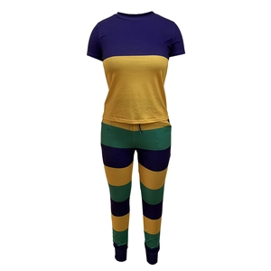 Detail of two-piece set featuring purple and yellow color block top and striped jogger pants