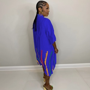 Detail of royal blue midi dress featuring colorful vertical stripes and loose fit pockets