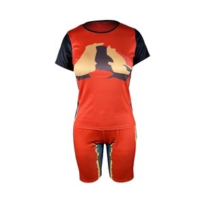Detailed view of women's two-piece sports set with orange tie-dye patterns and black sleeves