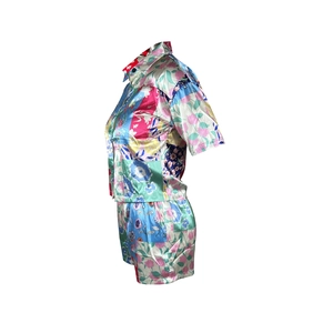 Close-up of floral print satin fabric texture and lapel collar on two-piece set
