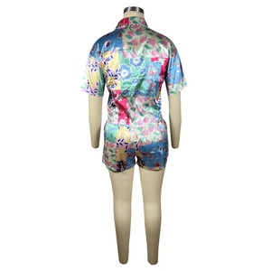 Detail of floral patchwork satin two-piece pajama set showing back view on a mannequin