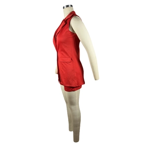 Side view of red sleeveless blazer with lapel collar on a mannequin showing tailored details