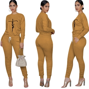 Detail view of Faith cross print on ginger crewneck sweatshirt and jogger pants set