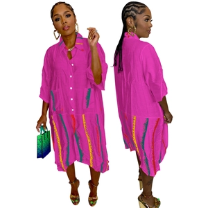 Close-up of fuchsia shirt dress featuring artistic colorful print and large utility pockets