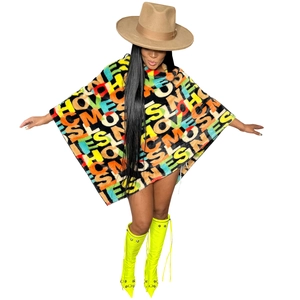 Close-up of vibrant faux fur cloak with colorful letter prints and plush texture