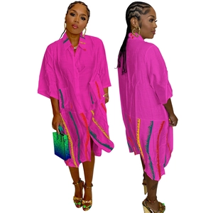 Detail of fuchsia shirt dress with abstract color stripes and large pockets for women
