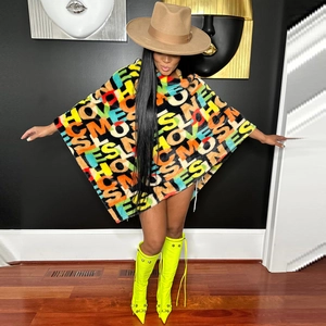Detail of oversized velvet poncho featuring colorful graffiti letter print and batwing sleeves