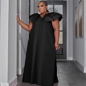 Detail of plus size black maxi dress featuring exaggerated ruffle trim and deep V-neckline