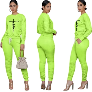 Three-way view of neon green faith printed sweatshirt and stacked ruched ankle pants set