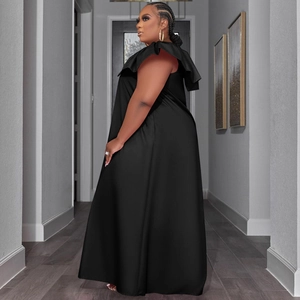 Detail of the elegant black sleeveless maxi dress with layered ruffle shoulders and a-line hem
