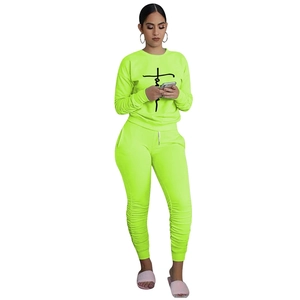 Detail of neon green loungewear set with faith cross print on the chest