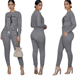 Detail of grey two-piece set featuring pleated cuffs and faith cross print design